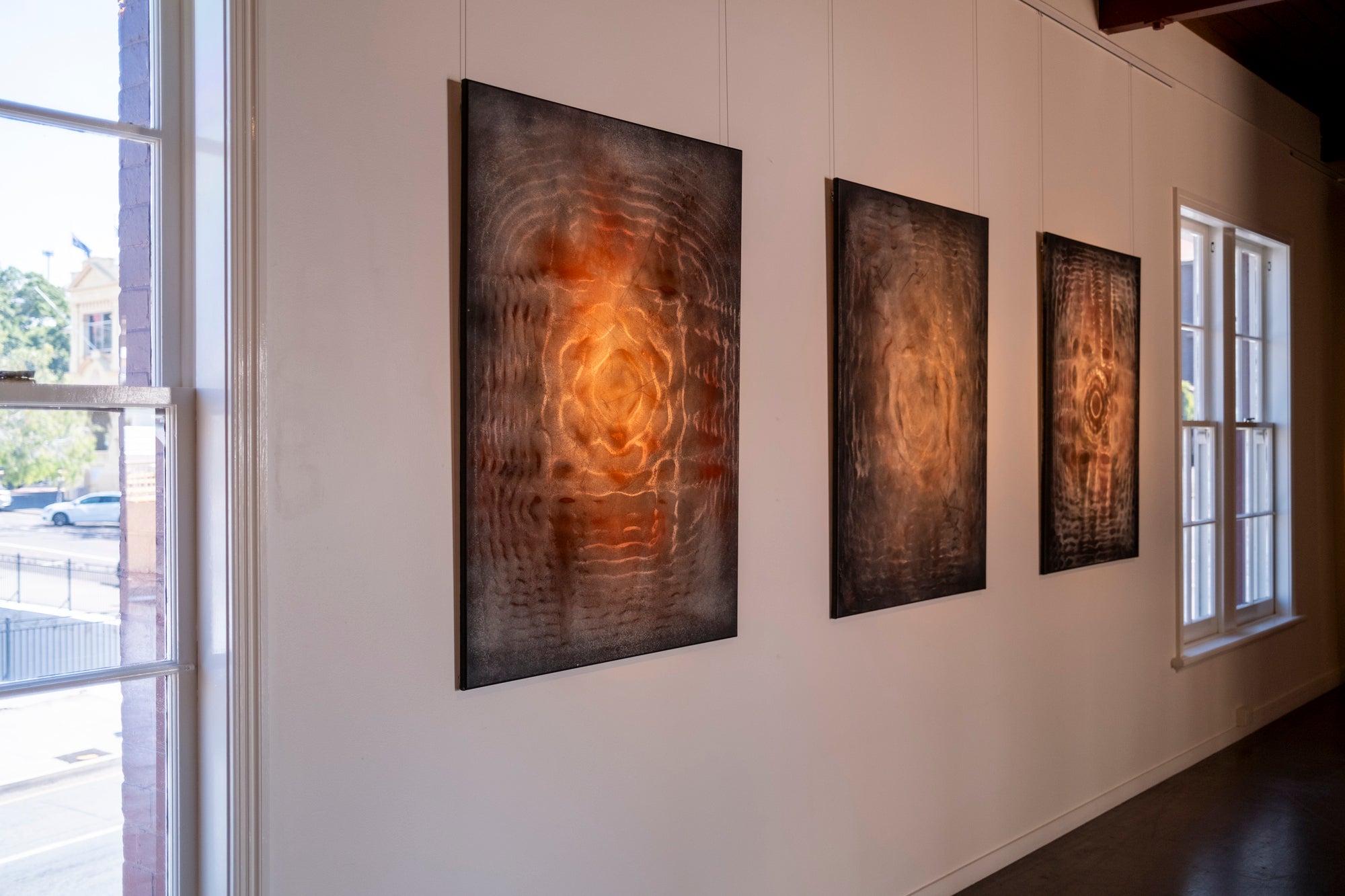 Large original cymatics chladni painting displayed in gallery — sound vibration art with earth pigments on canvas