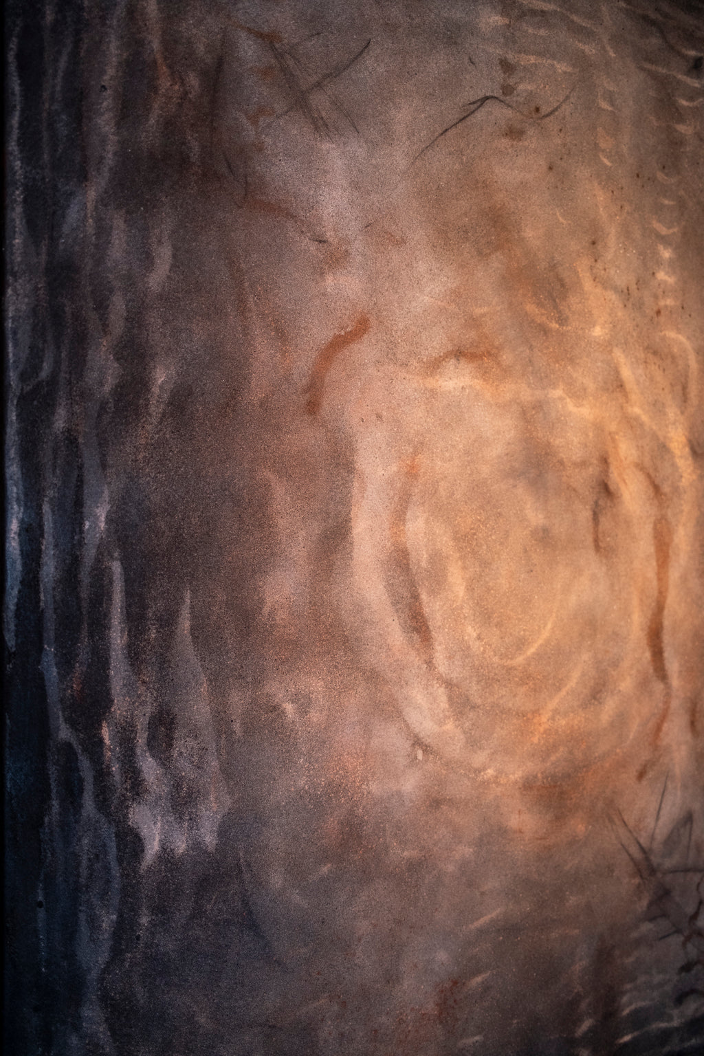 Abstract painting with swirling patterns in brown and black tones