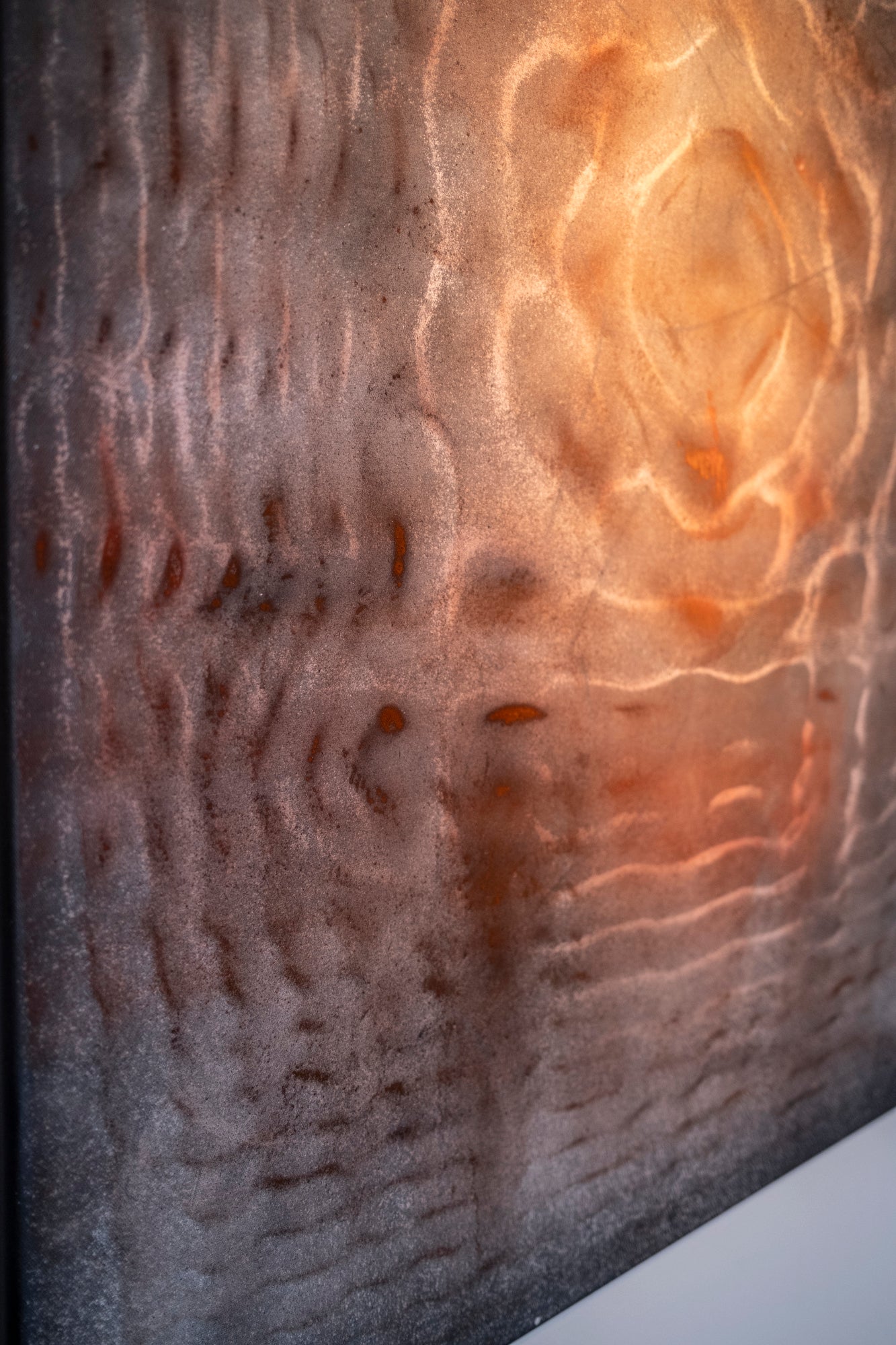 Close up detail of cymatics resonance painting showing earth pigment and charcoal patterns formed by sound