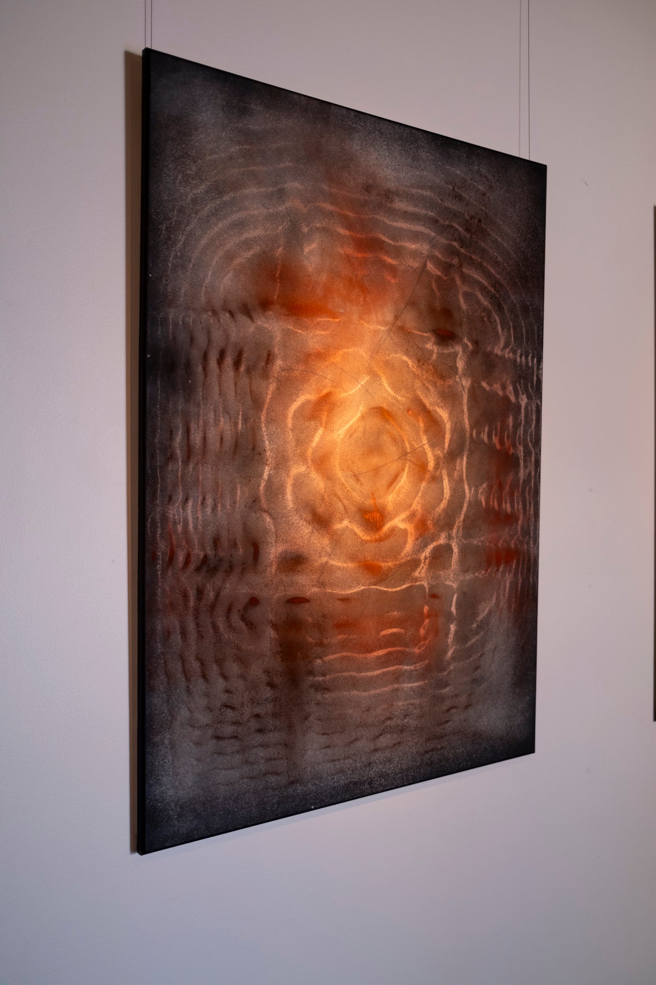 Large original cymatics painting displayed in gallery — sound vibration art with earth pigments on canvas