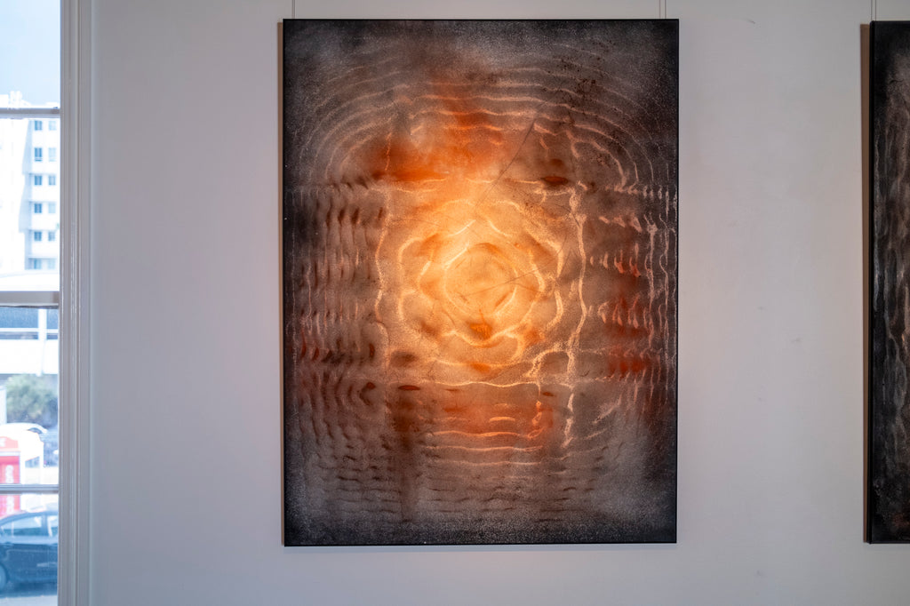 Large original cymatics painting displayed in gallery — sound vibration art with earth pigments on canvas