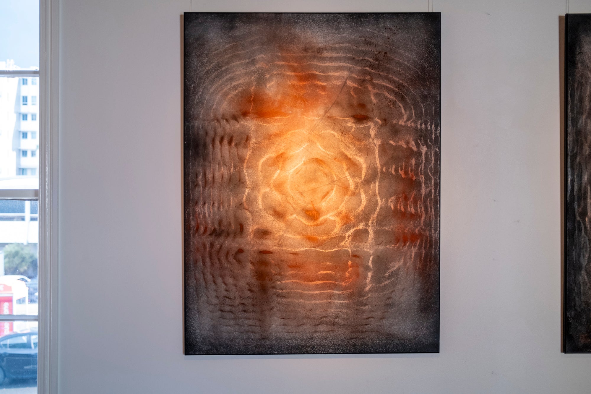 Large original cymatics painting displayed in gallery — sound vibration art with earth pigments on canvas