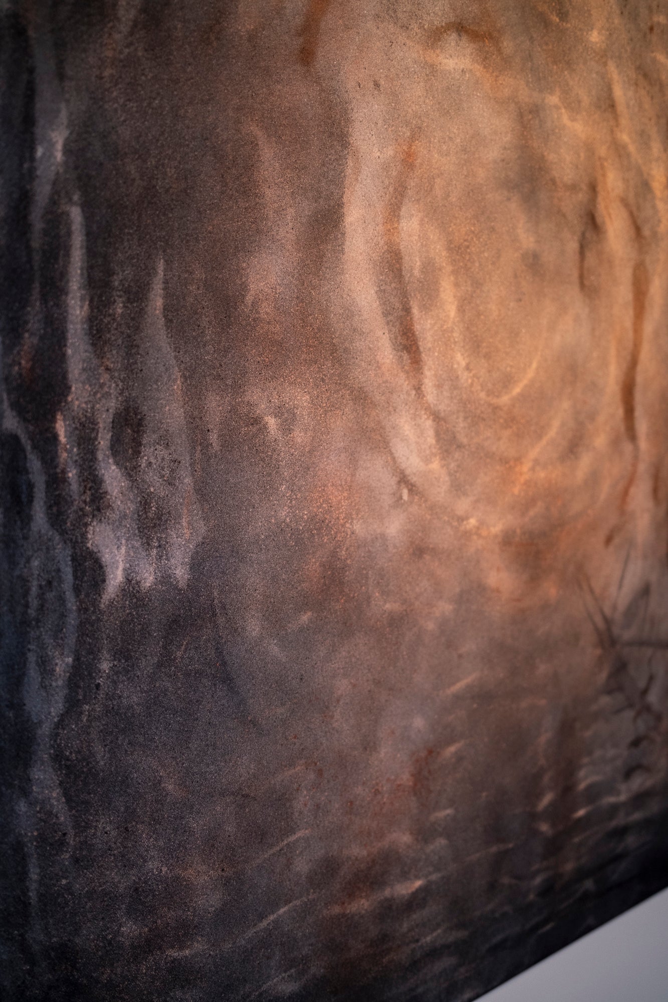 Close-up of textured stone surface with variations in color of cymatics artwork