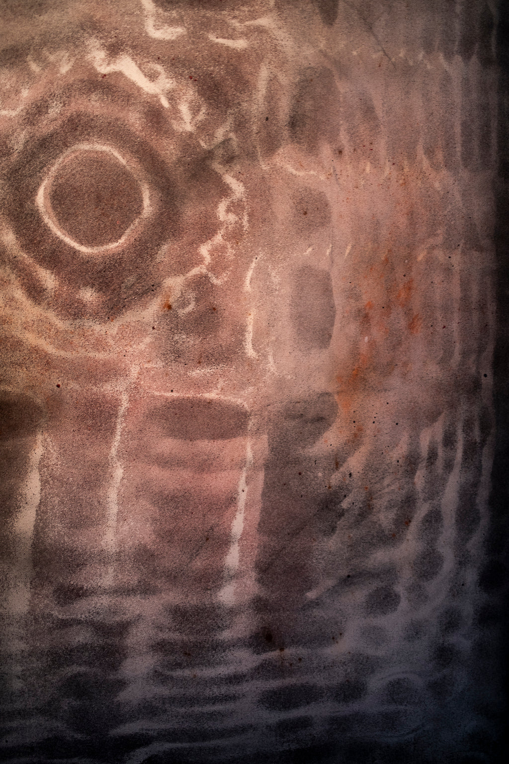 Close up detail of cymatics resonance painting showing earth pigment and charcoal patterns formed by sound vibration, cymatics chladni artwork